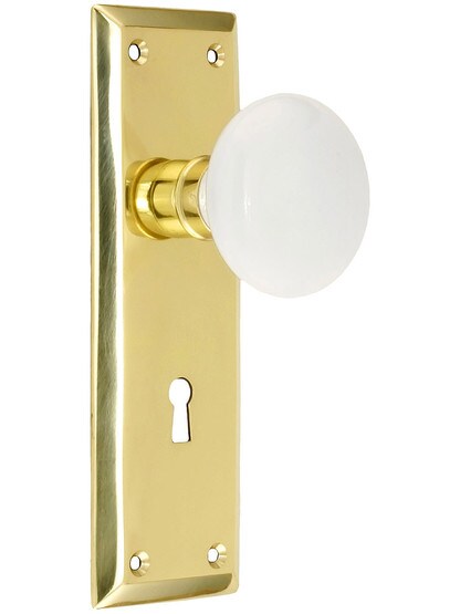 Classic New York Style Mortise Lock Set in Polished Brass Finish with White Porcelain Door Knobs.